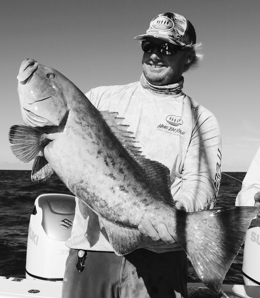 Angler holding up a large gag grouper