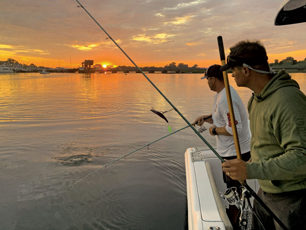 Fishing for striped bass at sunset