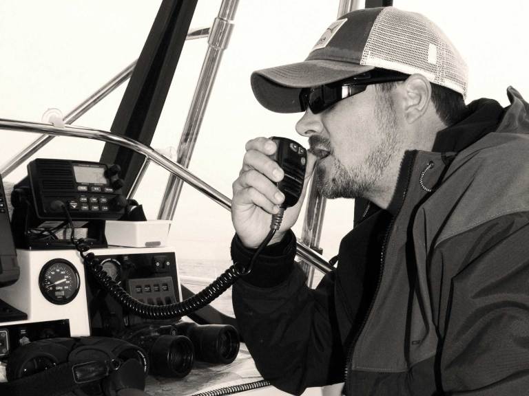 Angler using a VHF radio