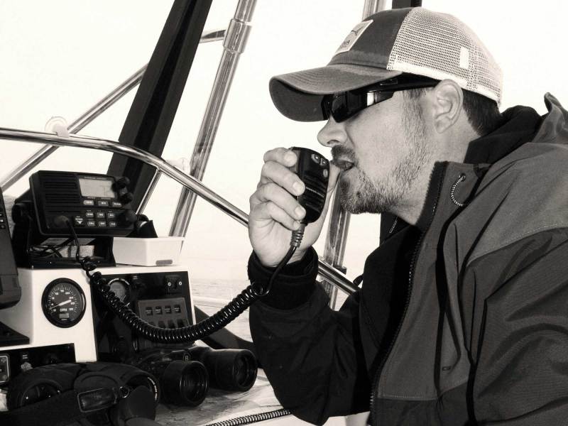 SWS1025-ELC-VHF-1 Angler using a VHF radio