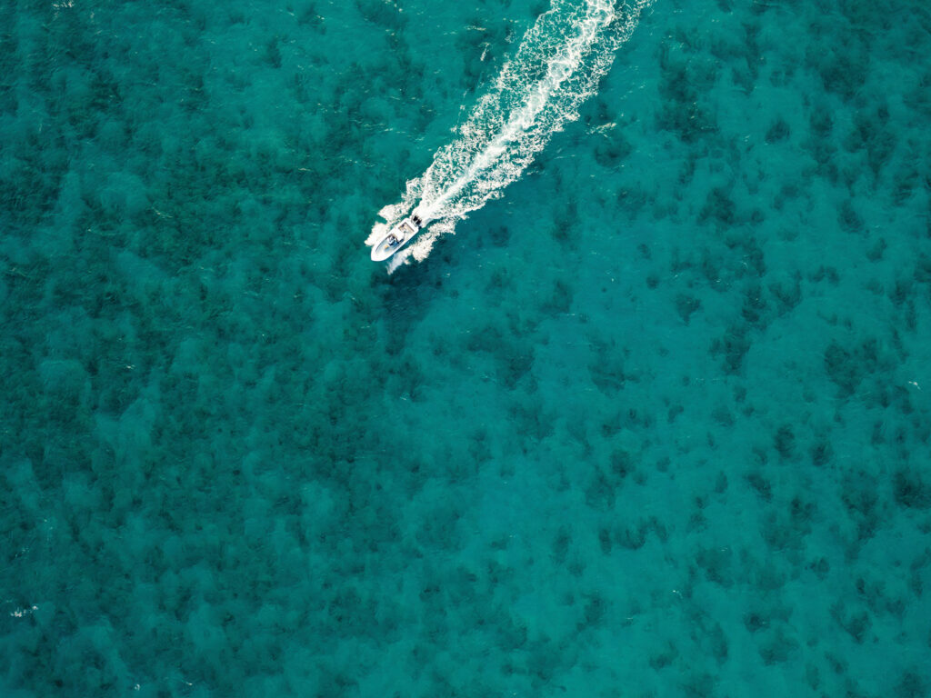 Fishing boat running above the reef
