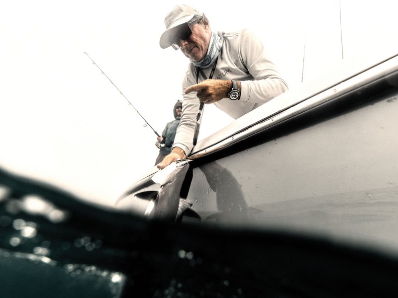Angler catching fish using Quantum gear