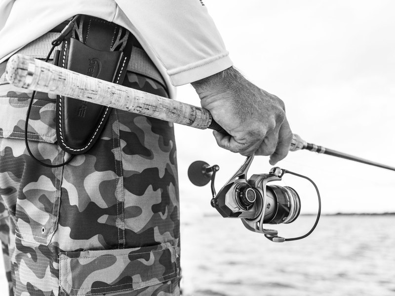 Angler holding Quantum fishing gear