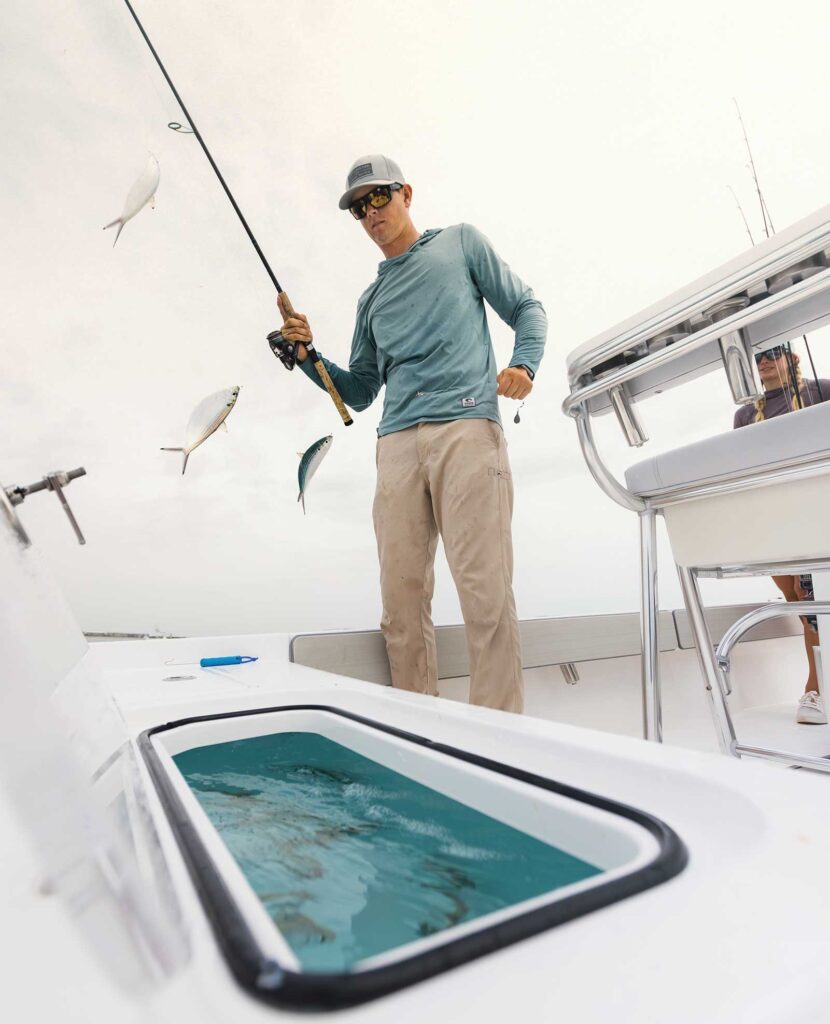 Angler taking bait from livewell