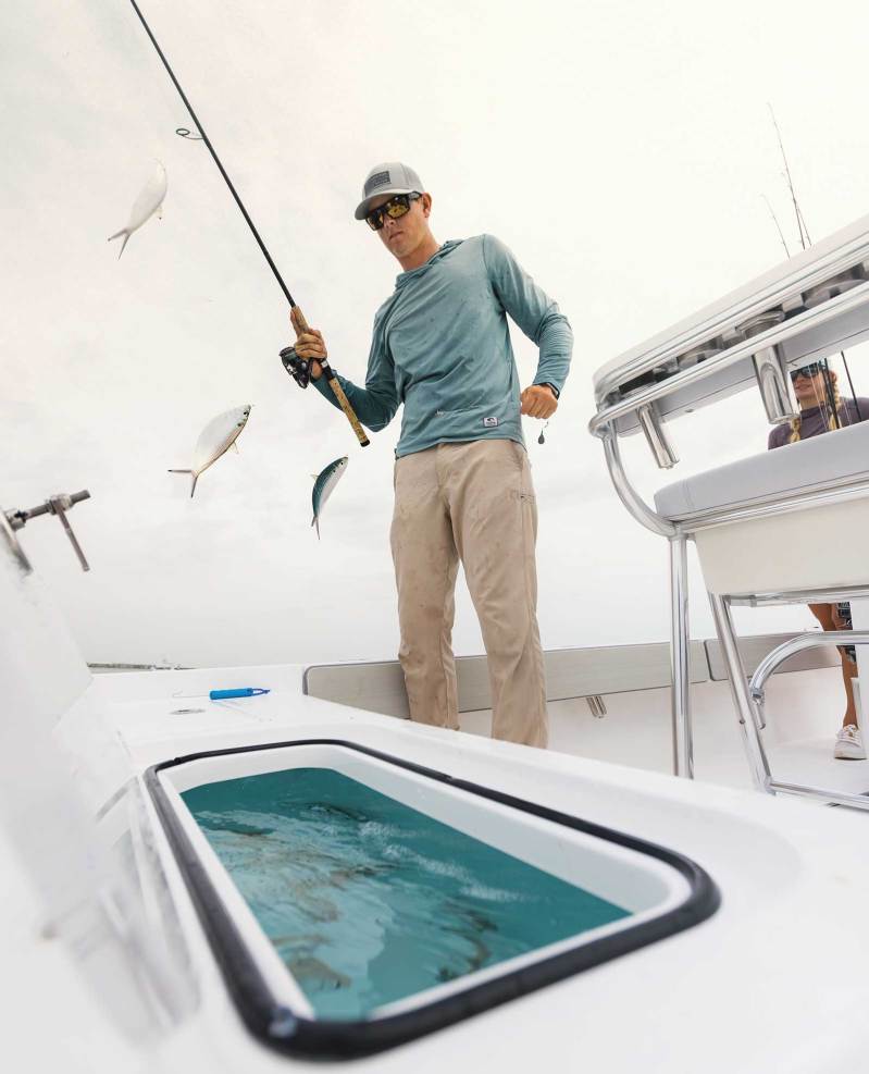 Angler taking bait from livewell