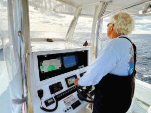 Angler at the helm watching fish finder screens