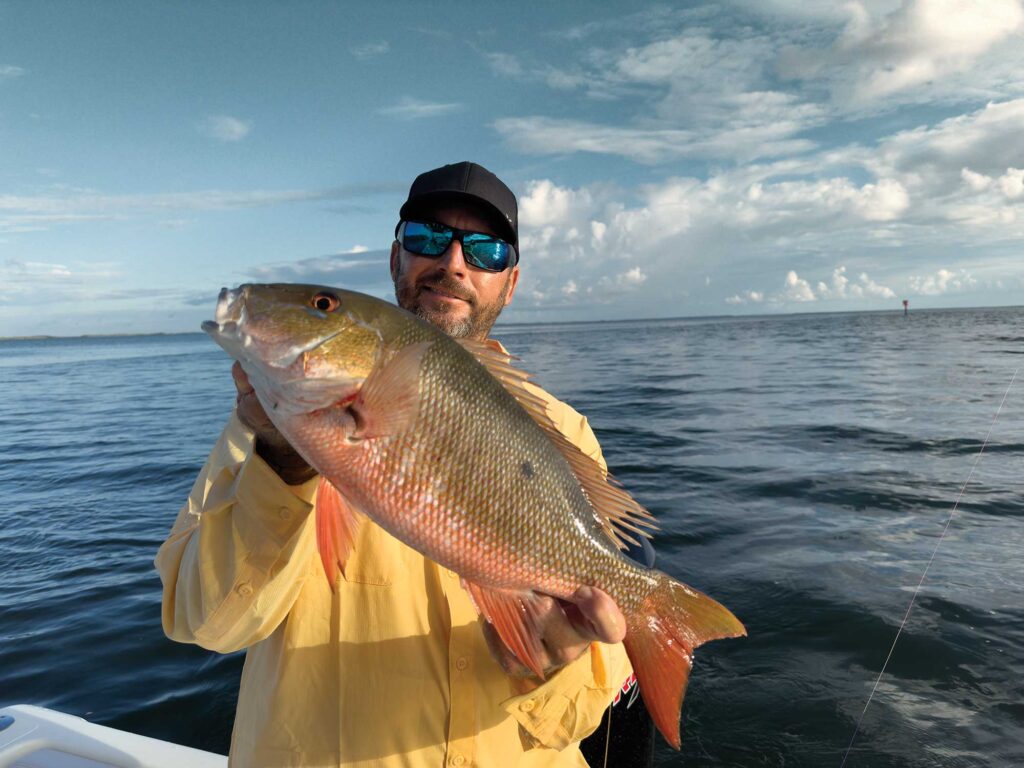 Angler with large mutton snapper