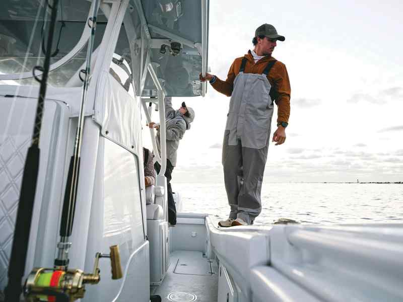 Angler wearing bib overalls