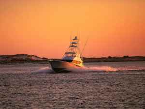 SWS726-PuGOQLLfy58-unsplash Fishing boat at sunrise