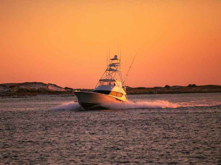 SWS726-PuGOQLLfy58-unsplash Fishing boat at sunrise