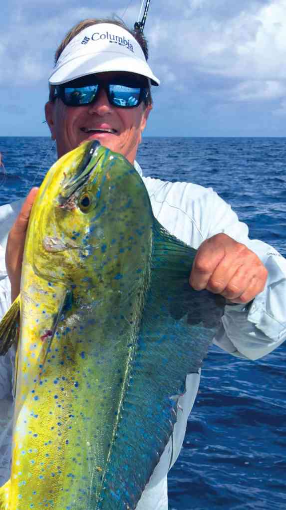 Angler with mahi on the boat