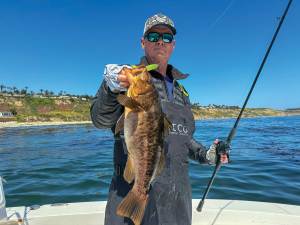 SWS926-Calico-Top-2 Angler holding calico bass on boat